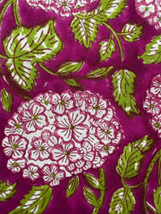 Close-up of fabric with floral pattern on a purple background
