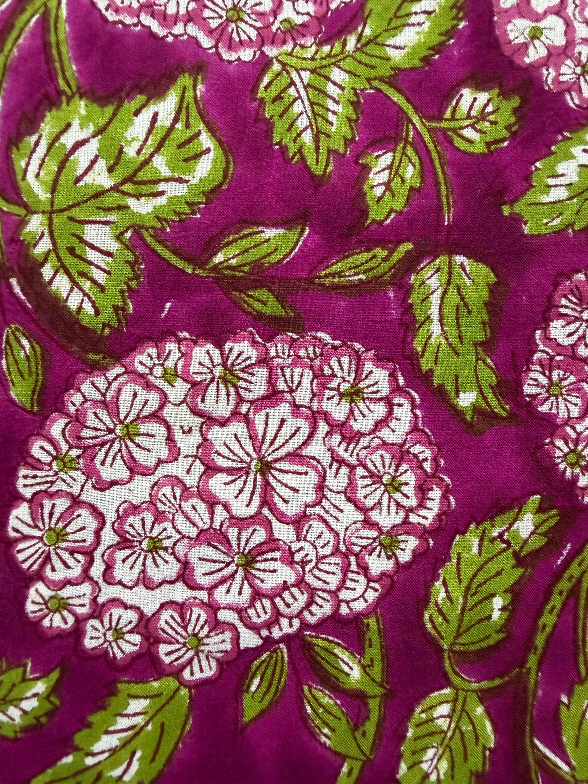Close-up of fabric with floral pattern on a purple background