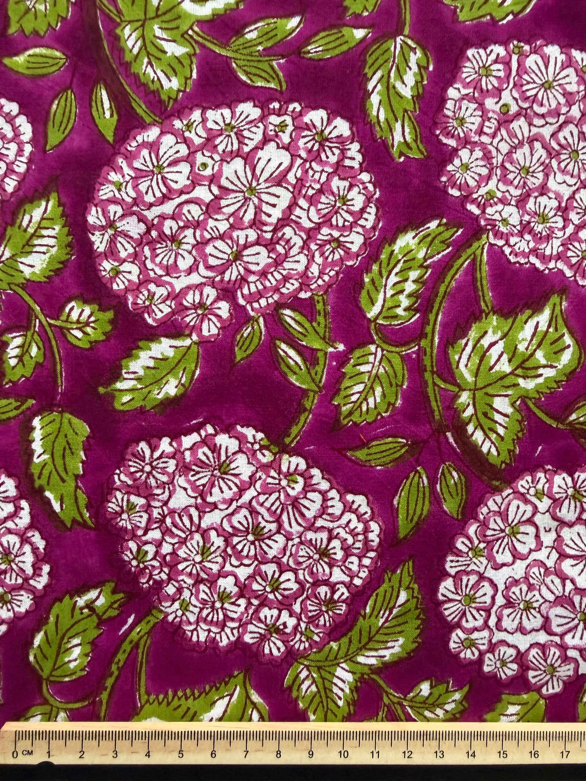 Close-up of fabric with floral pattern on a purple background