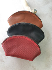 Unstitched cross-stitch leather makeup bags in tan, black and burgundy