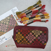 Cross-stitch leather zipper pouch kit with embroidery threads, pattern and floral pouch