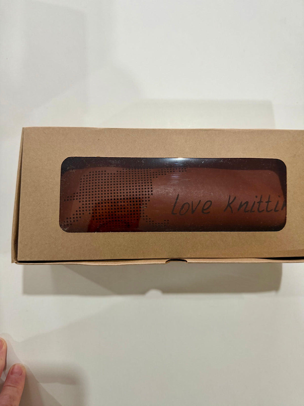 Tan leather cross-stitch pencil case in a kraft gift box with a clear window